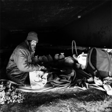 Homeless Man living under a bridge