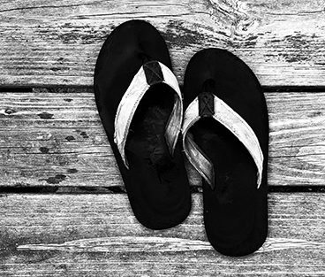 flip flops on a wooden deck