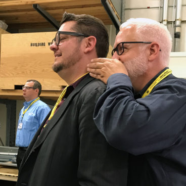 Bob Borson whispering secrets to Andrew Hawkins